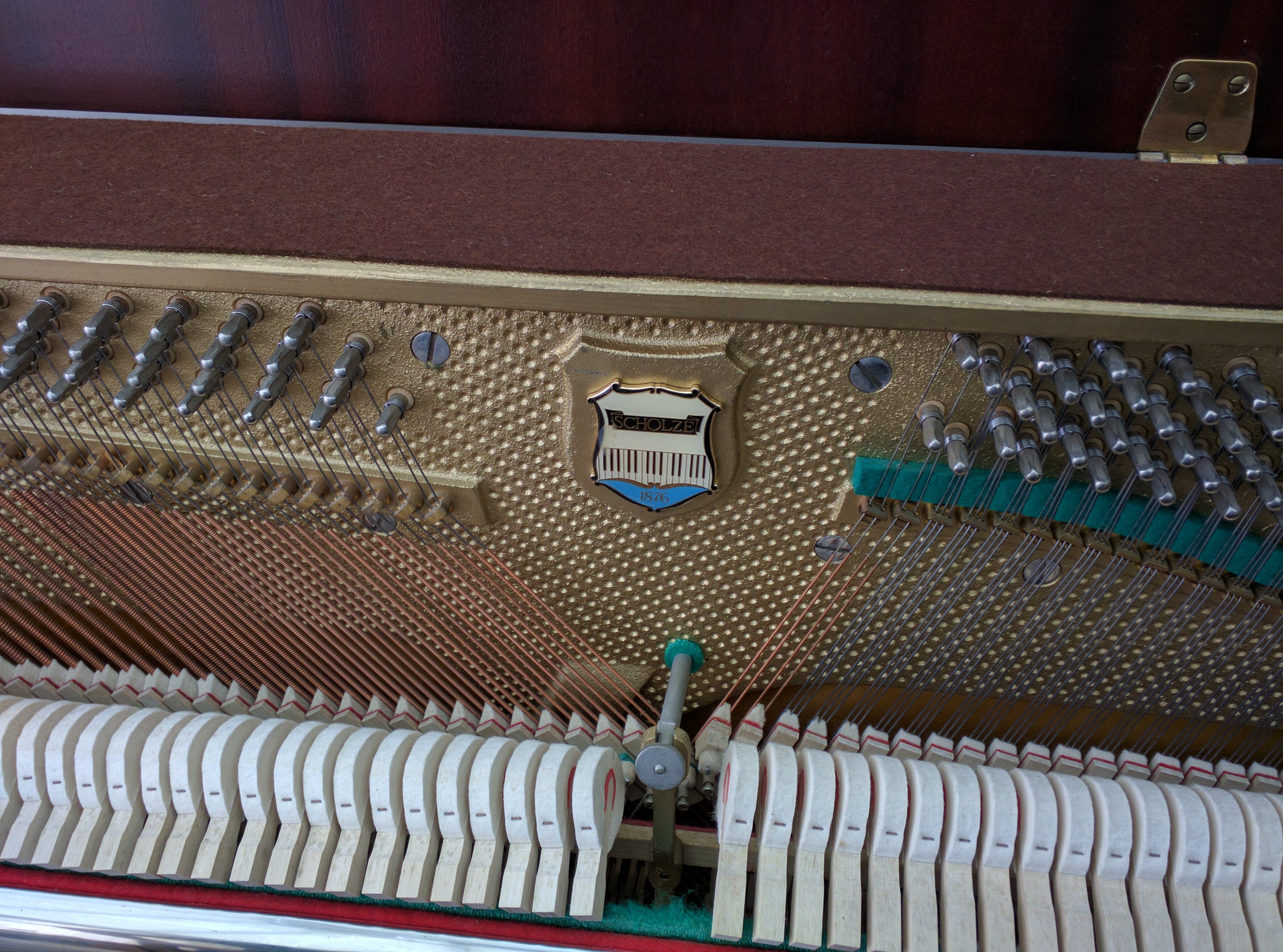 Close Up of internals of Scholze Upright Piano (petrof trademark badge)